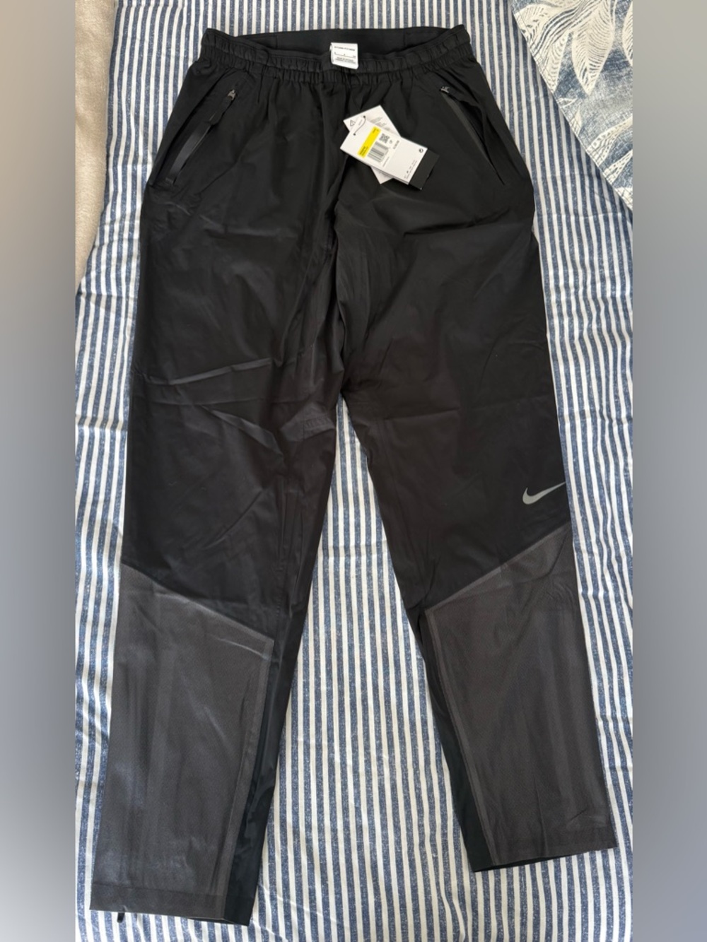 Nike Black Women's Track Joggers with Mesh Panels and Reflective Swoosh